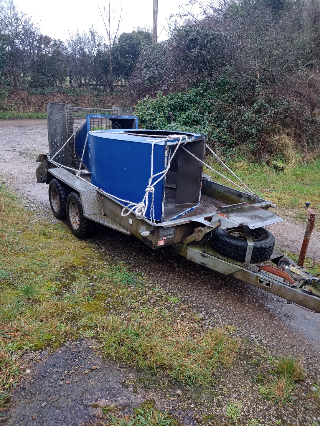 Dismantled blue fan casing on a trailer for transport to the workshop