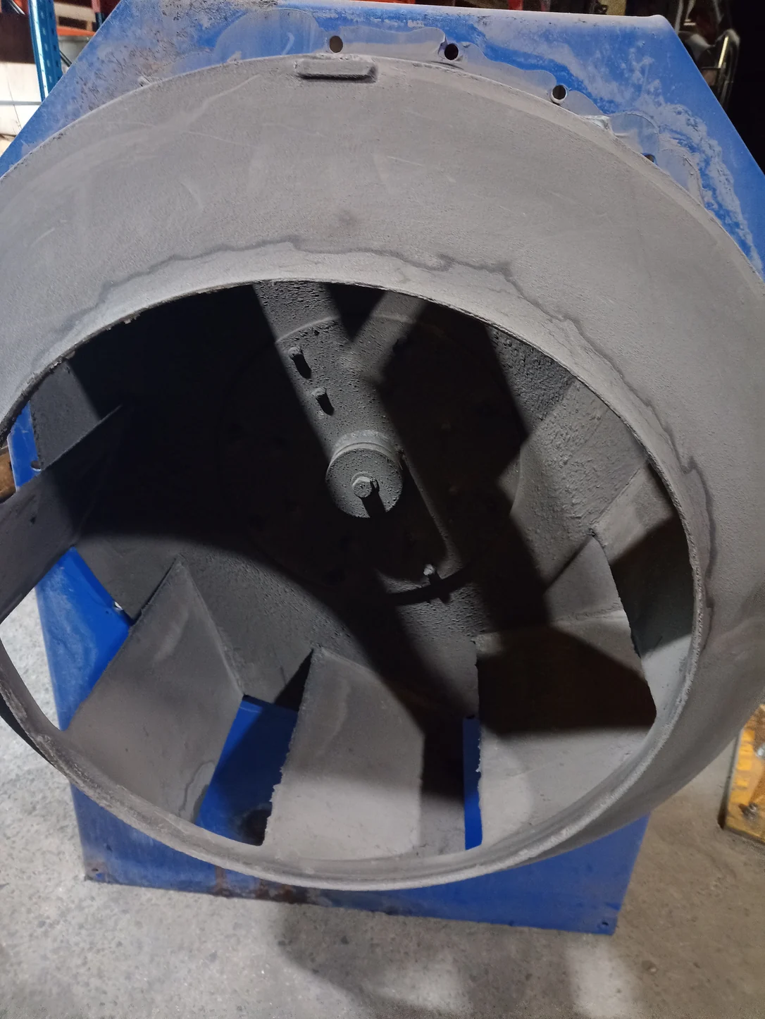 Dust-covered centrifugal fan impeller exposed during the strip-down