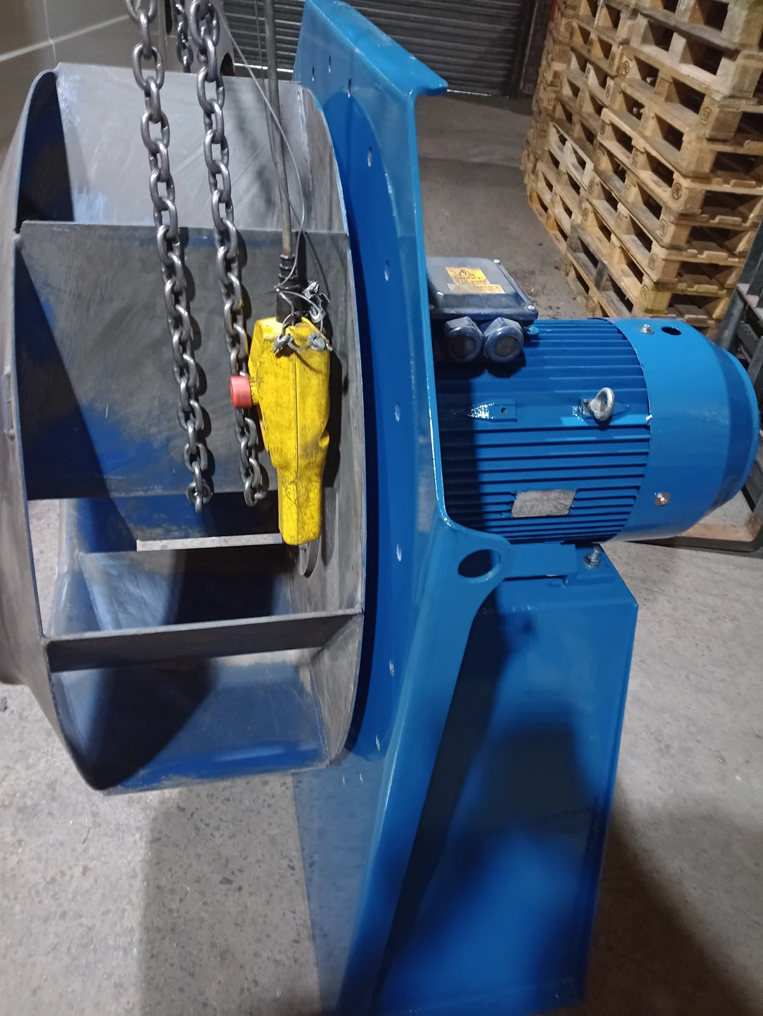 Motor, fan impeller and blue pedestal with chain lifting equipment during the refurbishment